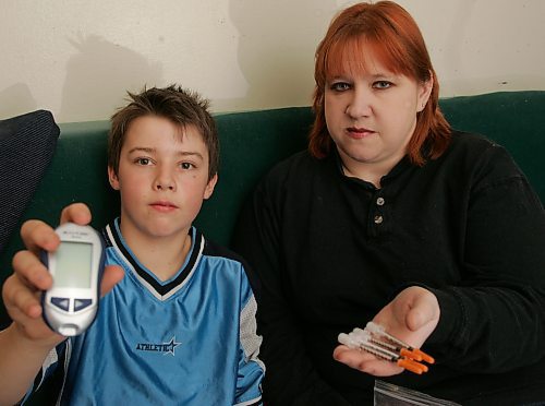 BORIS MINKEVICH / WINNIPEG FREE PRESS  070308 Diabetic Zachary Lemay with his mom Sheri Lemay show the things that Zachary uses to deal with his condition. They are wanting a insulin pump paid by the MB government.