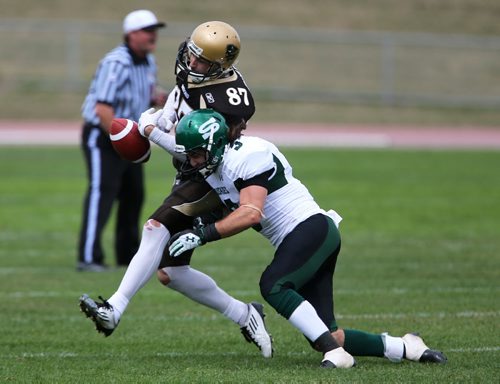 Saskatchewan Huskies' Braxton Lawrence, right, delivers a jarring hit to Manitoba Bisons' Danny Turek, causing him to fumble the ball during their game at the University of Manitoba, September 8, 2012. The pass would fall incomplete. (TREVOR HAGAN/WINNIPEG FREE PRESS)