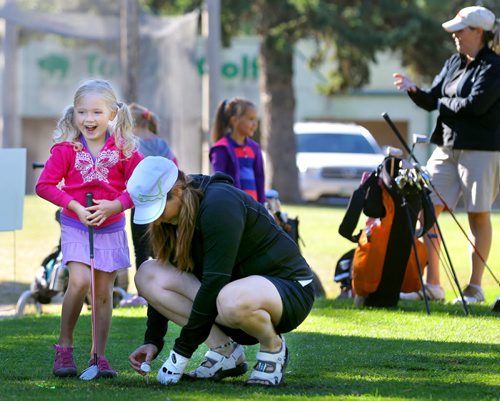 Brandon Sun London Peter is all smiles as she prepares to make her first tee-off, with some help from her mother Bobbi, during the Brandon Sun Mother-Daughter Golf Tournament, Sunday morning at Northern Pines golf course. (Colin Corneau)