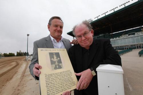 Assiniboia Downs CEO Darren Dunn - left and Horseracing historian Robert (Bob) Gates hold plaque with photo of the original Manitoba Derby trophy that  was presented at the original Polo Park track and has gone missing.  See Al Besson's story. Sept 13,  2012 (Ruth Bonneville/Winnipeg Free Press)