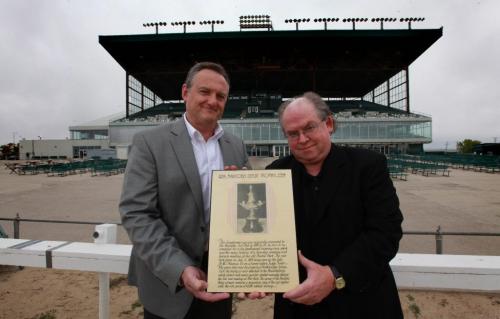 Assiniboia Downs CEO Darren Dunn - left and Horseracing historian Robert (Bob) Gates hold plaque with photo of the original Manitoba Derby trophy that was presented at the original Polo Park track and has gone missing.  See Al Besson's story. Sept 13,  2012 (Ruth Bonneville/Winnipeg Free Press)