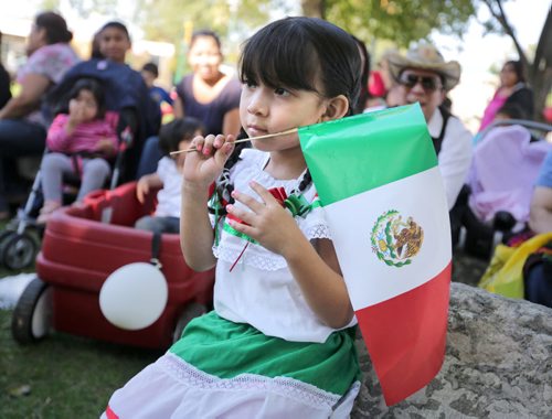 Brandon Sun Oriana Martinez holds a Mexican flag as she watches the entertainment in Princess Park, Saturday afternoon. Both Mexico and El Salvador celebrated their respective independence days on Saturday, and the local community marked the occasion with music, dance and cultural displays both in the downtown and in Dinsdale Park. (Colin Corneau/Brandon Sun)