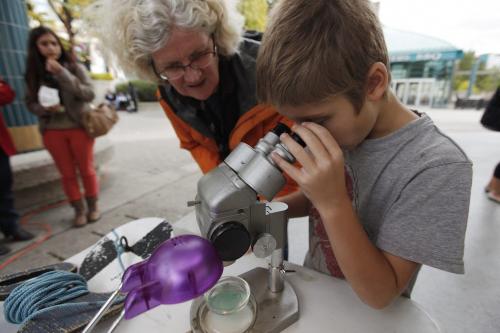 September 16, 2012 - 120916  -  Willie Findlay, a former research technician at the Experimental Lake Area (ELA), assists eight year old Tim Gerbrandt look at some blue-green algae from Grand Beach during a rally   to help save the ELA at The Forks Sunday September 16, 2012.    John Woods / Winnipeg Free Press