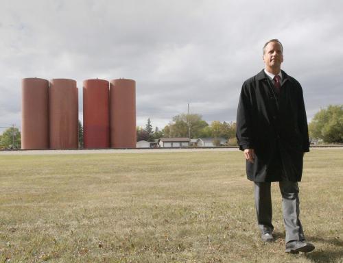 City of Winnipeg councilor John Orliko walks away from giant metal silos being that were erected on the BNSF Railway line on Lindsay Street and Mathers Avenue last week- local residents say they do not belong in a residential neighborhood  See Alex Paul story  September 17, 2012   (JOE BRYKSA / WINNIPEG FREE PRESS)