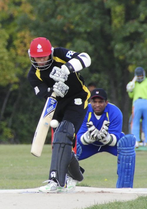 A premier cricket match between Cosmos (black) and Bloomfield (blue) at the Assiniboine Park pitch Sunday afternoon. Batsman for Cosmos, Waleed Ahmed, hits at the ball during the afternoon match. 120916 - Sunday, September 16, 2012 -  (MIKE DEAL / WINNIPEG FREE PRESS)