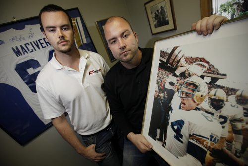 September 18, 2012 - 120918  -  Andrew (L) and Doug MacIver pose for a photograph with a photograph of their dad and CFL player Doug MacIver Tuesday September 17, 2012. MacIver died in January and his brain was donated for research. John Woods / Winnipeg Free Press