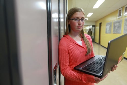 Grade ten Dakota Collegiate student Kirsten McWhirter stands in the hallway of her high school with her laptop that she had to have to as part of her school supplies.  See Nick Martin story. Sept 19,  2012 (Ruth Bonneville/Winnipeg Free Press)
