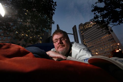 Winnipeg Free Press columnist Doug Speirs gets ready to sleep under the stars along with local CEO's, and community leaders listen to speeches before they spend the night outside on the corner of Portage and Main for the annual CEO Sleepout that raises money for the homeless. Standup photo. Sept 27,  2012 (Ruth Bonneville/Winnipeg Free Press)