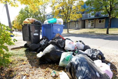 New garbage bins overflow with bags of extra garbage surounding bins in the west end. Sept 29,  2012 (Ruth Bonneville/Winnipeg Free Press)