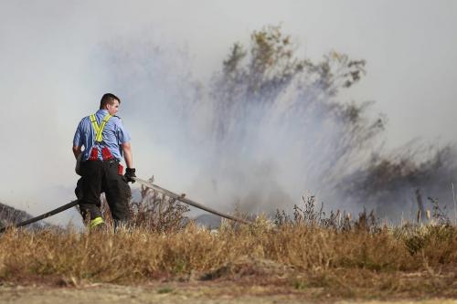 September 30, 2012 - 120930  -  Firefighters work to extinguish a bush fire off Loudoun Road Sunday September 30, 2012.  John Woods / Winnipeg Free Press