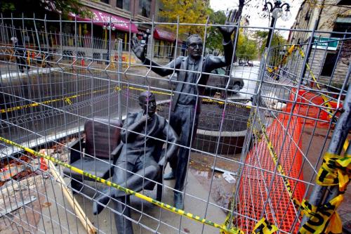 Construction on Market has statues of John Hirsch and Tom Hendry caged in. The life-size bronze, called Imagine, MTC', features John Hirsch standing with arms extended behind Tom Hendry, who is seated in one of two theatre seats, while they discuss their vision for MTC. A plaque adorns the empty seat next to Tom. The sculpture was permanently installed outside of MTC's box office entrance on Friday, October 24. It was generously supported by Babs and Gail Asper and Michael Paterson, and the Johnston Group in honour of Marjorie Johnston, former MTC Board President. The theatre was founded in 1958 by John Hirsch and Tom Hendry as an amalgamation of the Winnipeg Little Theatre and Theatre 77. In 2010, the theatre was honoured to receive royal designation from Her Majesty Queen Elizabeth II, and officially became the Royal Manitoba Theatre Centre. (from internet) October 5, 2012  BORIS MINKEVICH / WINNIPEG FREE PRESS