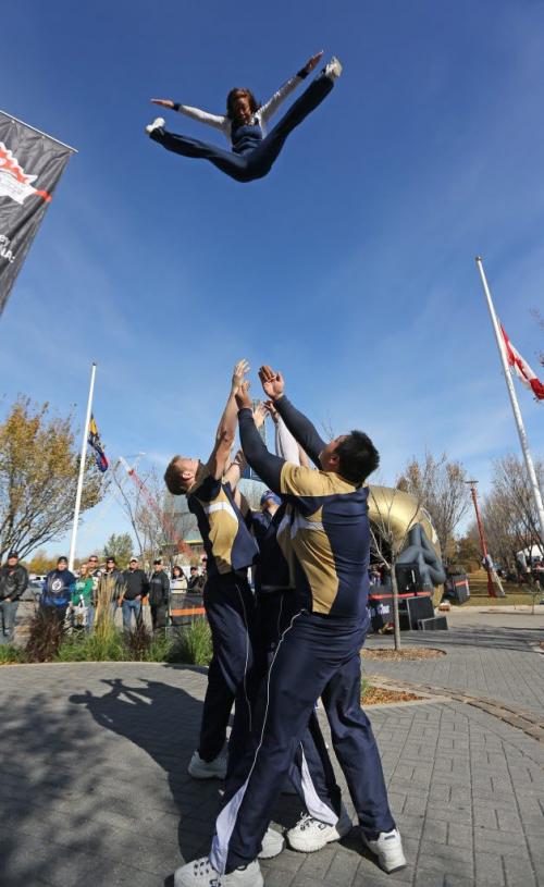 Danessa Picard of the Blue Bomber Cheer Team soars through the air during the Grey Cup 100 Train Tour festivities at The Forks, Saturday, October 6, 2012. (TREVOR HAGAN/WINNIPEG FREE PRESS) - see alex paul story