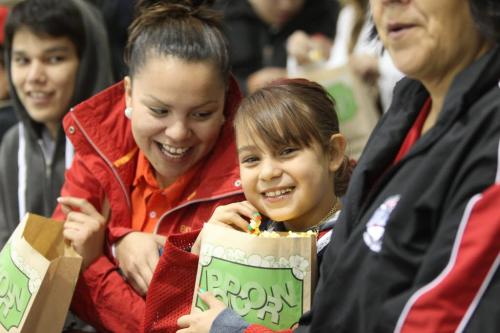 Fans of the OCN Blizzards smile as they eat popcorn during the game against the Portage Terriers at the  Old Dutch MJHL Showcase Tournament  at IcePlex Arena Saturday. The OCN Blizzard won the game  2 -1 in a shootout. See Randy Turner's  Native, Aboriginal hockey story Oct 06,  2012 (Ruth Bonneville/Winnipeg Free Press)