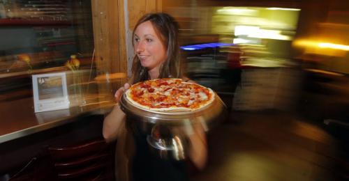 Corrientes Argentine Pizzeria review. Manager Cynthia Murray whisks by with a Crudo pizza inside the restaurant. Crudo pizza has Prosciutto, Buffalo Mozzarella and Sun Dried Tomato on it. October 9, 2012  BORIS MINKEVICH / WINNIPEG FREE PRESS