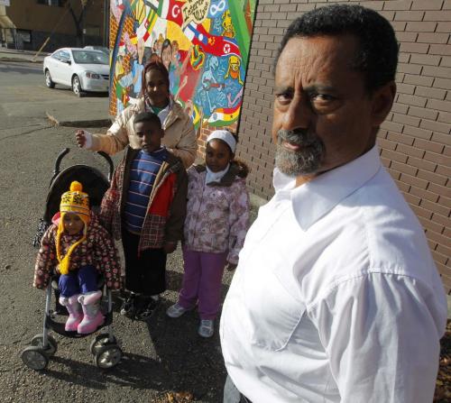 Human Rights activist Ali Saeed poses for a photo with family that is having problems with getting Canadian Citizenship. Mother-Chilot Zegeye, son- Alemayo Yirdaw, daughter- Womnesh Yirdaw, and baby in stroller daughter-Tigist Yirdaw. October 11, 2012  BORIS MINKEVICH / WINNIPEG FREE PRESS