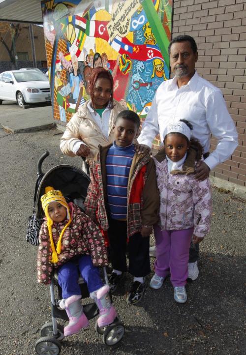 Human Rights activist Ali Saeed poses for a photo with family that is having problems with getting Canadian Citizenship. Mother-Chilot Zegeye, son- Alemayo Yirdaw, daughter- Womnesh Yirdaw, and baby in stroller daughter-Tigist Yirdaw. October 11, 2012  BORIS MINKEVICH / WINNIPEG FREE PRESS