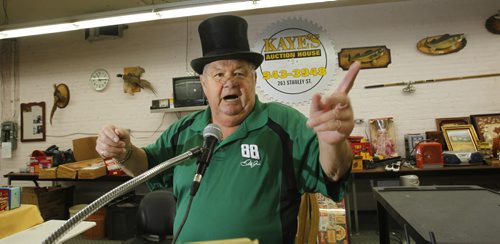 Sunday Xtra. Auctioneer Andy Kaye owner of Kaye's Auction House Inc. on Stanley St. shows some of his auctioneering skills. He is wearing the top hat and glasses he keeps on display.         (WAYNE GLOWACKI/WINNIPEG FREE PRESS) Winnipeg Free Press  Oct.18  2012