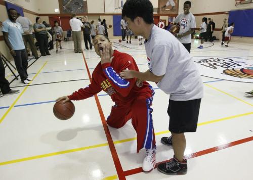 October 23, 2012 - 121023  -  Handles Franklin of the Harlem Globetrotters shows off with Jalen Merluza and other young players at the Magnus Eliason Recreation Centre after an unveiling of upgrades and a basketball demonstration and clinic Tuesday October 23, 2012. John Woods / Winnipeg Free Press