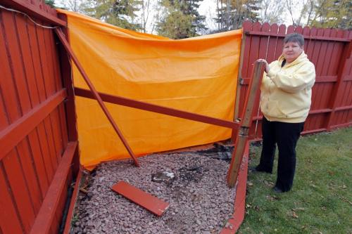 Terry Cannon who lives at 130 Southwalk Bay in South St. Vital had her fence torn apart by a garbage truck. Here she poses with some evidence. October 25, 2012  BORIS MINKEVICH / WINNIPEG FREE PRESS