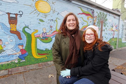 Volunteer column. Laurel Cassels poses with her daughter outside the West Central Women's Resource Centre. October 25, 2012  BORIS MINKEVICH / WINNIPEG FREE PRESS