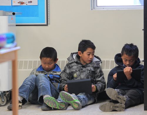 Brandon Sun A trio of friends use iPads in their classroom during a class Friday morning at King George School. DAY IN LIFE (Colin Corneau/Brandon Sun)