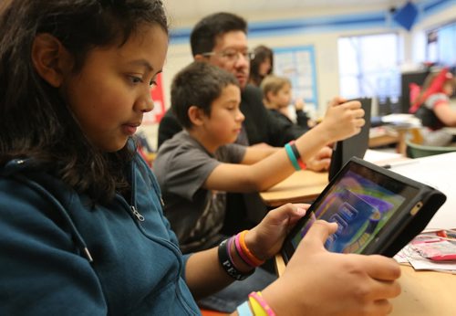Brandon Sun Jeannette Bonilla works with an iPad during morning classes at King George School. DAY IN LIFE (Colin Corneau/Brandon Sun)