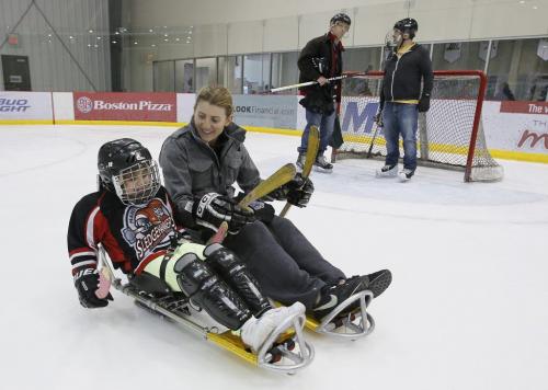 October 27, 2012 - 121027  -  Five time Olympian Hayley Wickenheiser got out on the ice today, Saturday October 27, 2012, in a means she is not used to and skated with Lily Rich and the kids from the junior program of the Manitoba Sledge Hockey Association organized by the Society of Manitobans with Disabilities at the MTS Iceplex in Winnipeg. Wickenheiser was in town playing for the University of Calgary against the University of Manitoba Bisons. John Woods / Winnipeg Free Press