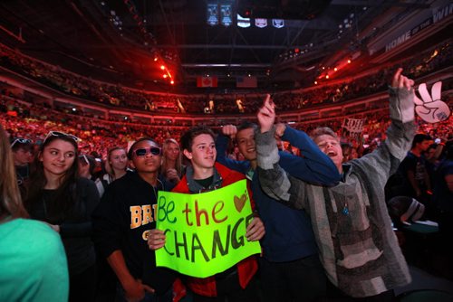 Henry Louris of Breck School in Minneapolis Minnesota holds a "Be the Change" sign with his classmates during 2012 We Day at MTS Centre Tuesday.  The annual We Day celebrations  in Winnipeg today with several iconic social activists and entertainers taking the stage at MTS Centre infront of 18,000 kids from around 400 schools from all over Manitoba. Marc Kielburger and his brother Craig  talk to the crowd at MTS Centre. Marc and Craig are internationally acclaimed childrens rights activists and co-founders of Free The Children. 121030 - Tuesday, October 30, 2012 - (RUTH BONNEVILLE / WINNIPEG FREE PRESS)   Ruth Bonneville