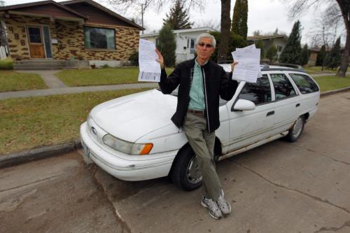 Yehuda Tcherni of 988 Queenston Bay poses for a photo with his ticket that he is going to fight. He's fighting the city over what he calls an unfair tow outside his house. October 30, 2012  BORIS MINKEVICH / WINNIPEG FREE PRESS