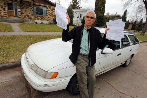 Yehuda Tcherni of 988 Queenston Bay poses for a photo with his ticket that he is going to fight. He's fighting the city over what he calls an unfair tow outside his house. October 30, 2012  BORIS MINKEVICH / WINNIPEG FREE PRESS