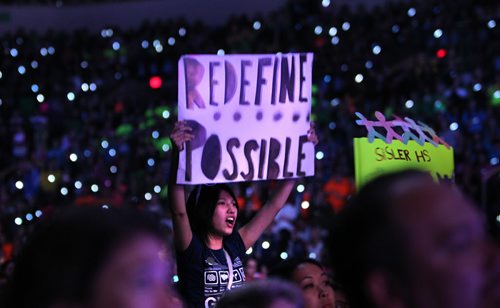 Grade nine student Samanta Beaulieu from Sisler High School holds "Redefine Possible" sign during "We Day" Tuesday afternoon at MTS Centre. The annual We Day celebrations  in Winnipeg today with several iconic social activists and entertainers taking the stage at MTS Centre infront of 18,000 kids from around 400 schools from all over Manitoba. Marc Kielburger and his brother Craig  talk to the crowd at MTS Centre. Marc and Craig are internationally acclaimed childrens rights activists and co-founders of Free The Children. 121030 - Tuesday, October 30, 2012 - (RUTH BONNEVILLE / WINNIPEG FREE PRESS)   Ruth Bonneville