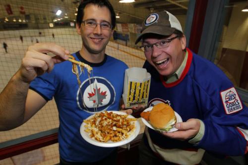 Chris Carman and Chris Zuk at Notre Dame Community Club with some Canteen food. Poutine, Popcorn, and real chicken burger. November 7, 2012  BORIS MINKEVICH / WINNIPEG FREE PRESS