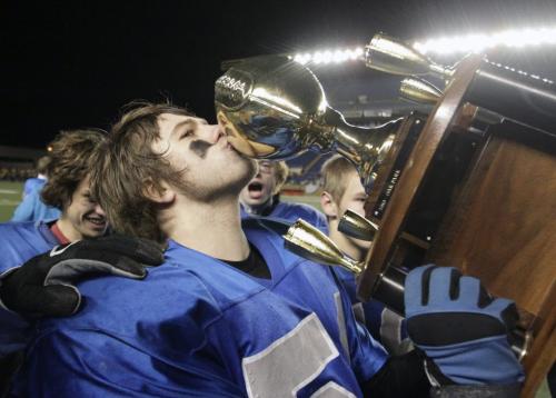 Oak Park Raiders Chris Swan (54) kisses the trophy after the team won the championship game 30-15. The Oak Park Raiders and Vincent Massey Trojans played in the Home Run Sports Bowl at Canad Inns Stadium Thursday evening. The Raiders won the game 30-15. 121108 - Thursday, November 08, 2012 -  (MIKE DEAL / WINNIPEG FREE PRESS)