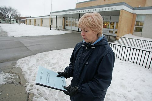 BORIS MINKEVICH / WINNIPEG FREE PRESS  070322 Elizabeth Evans poses for a photo with a clean air report in Transcona. Photo taken in front of Regent Park School.