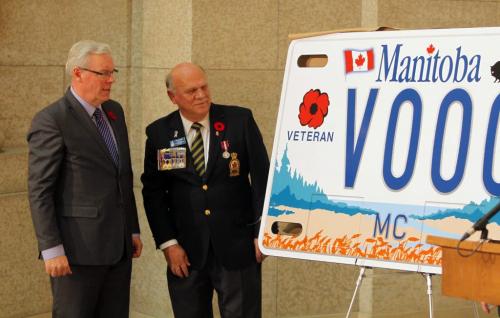 New speciality motorcycle licence plate for veterans.  Premier Greg Selinger and Rick Bennett, president, Manitoba/NW Ontario Command Members of local legions, and Rotunda, Legislative Building. unviel the new plate super sized. November 9, 2012  BORIS MINKEVICH / WINNIPEG FREE PRESS