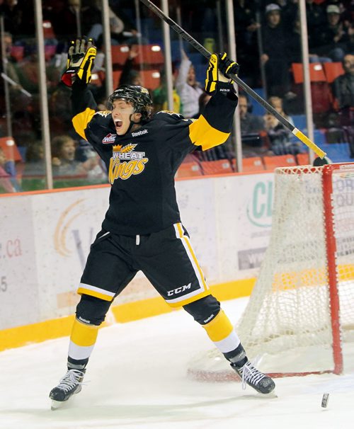 Brandon Sun 09112012 Geordie Maguire #26 of the Brandon Wheat Kings celebrates a goal by teammate Jayce Hawryluk #8 during WHL action against the Lethbridge Hurricanes at Westman Place on Friday evening. (Tim Smith/Brandon Sun)