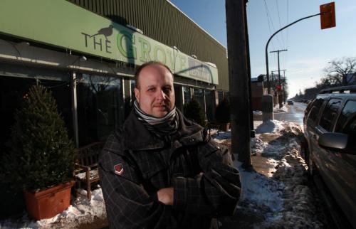 The Grove Corner of Stafford and Grosvenor Owner Miles Gould  outside to the plowed streets (his restaurant was almost vacant last night because customers feared getting towed by the 7 p.m. to 7 a.m. snow ban)t Nov 14 ,  2012 (Ruth Bonneville/Winnipeg Free Press)