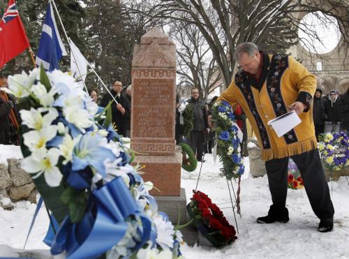 Manitoba Metis Federation president David Chartrand places a wreath at the gravesite of Metis Leader Louis Riel after a ceremony Friday to mark his death and celebrate his life and achievements. Wreaths were also placed by Premier Greg Selinger, Shelly Glover, MP,  Councillor Dan Vandal, Liberal Leader Dr. Jon Gerrard and representatives of the RCMP and Winnipeg Police.  (WAYNE GLOWACKI/WINNIPEG FREE PRESS) Winnipeg Free Press  Nov. 16    2012