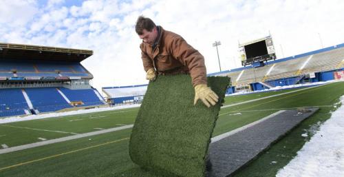 Todd Leathwood with a strip of the turf in the Canad Inn Stadium that will be cut up, framed and sold off.  Salvaging the Canad Inn Stadium story by Ed Tait  (WAYNE GLOWACKI/WINNIPEG FREE PRESS) Winnipeg Free Press  Nov. 16    2012