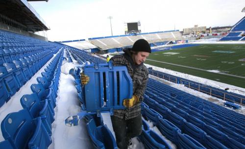 Garrett Iverson helps remove seats purchased by season ticket holders in the Canad Inn Stadium. For Salvaging the Canad Inn Stadium story by Ed Tait  (WAYNE GLOWACKI/WINNIPEG FREE PRESS) Winnipeg Free Press  Nov. 16    2012