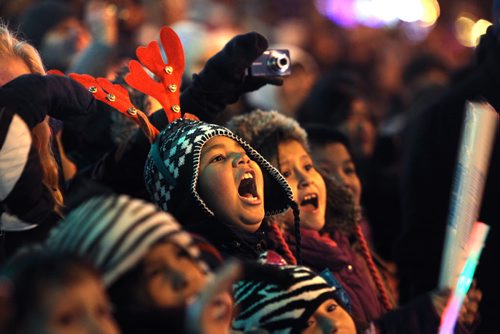 Crowds of wide eyed children gather with thier famiilies  along Portage Ave. Saturday evening during the annual Santa Claus Parade. Eight year old Mason Buechert admires the flaming fire on one of the floats while watching the parade. Nov 17 ,  2012 (Ruth Bonneville/Winnipeg Free Press)