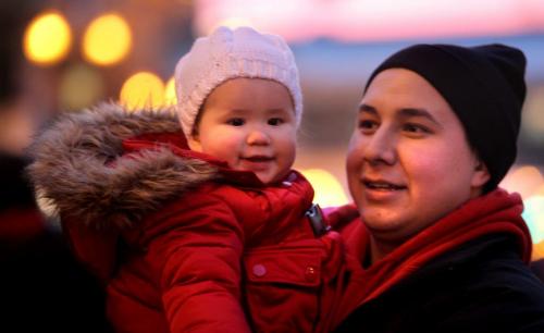 Crowds of wide eyed children gather with thier famiilies  along Portage Ave. Saturday evening during the annual Santa Claus Parade. Fifteen month old Avery Shaw enjoys the parade with dad Chris Shaw. Nov 17 ,  2012 (Ruth Bonneville/Winnipeg Free Press)