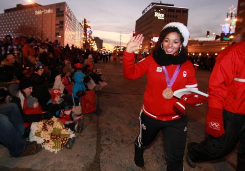Desiree Scott Olympic medal winner waves to the crowds as se makes her way down Portage Ave. during the annual Santa Claus Parade Saturday evening. Nov 17 ,  2012 (Ruth Bonneville/Winnipeg Free Press)