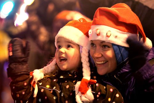 Three year old Makaela McMurray and her mom are all smiles as they wave to Santa on Portage Ave. Saturday evening during the annual Santa Claus Parade. Nov 17 ,  2012 (Ruth Bonneville/Winnipeg Free Press)