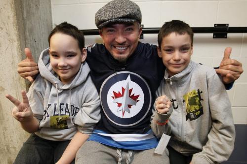 November 18, 2012 - 121118  -  Cole Hein (L) and his brother Eric pose for a picture with Cesar Millan at the MTS Centre. Cole Hein (11) and his family Eric (11), mother Mandy, and father Dwayne meet Cesar Millan prior to Millan's show at the MTS Centre Sunday November 18, 2012. Hein's dog Bingo was trained to bark to alert his parents whenever the child stopped breathing. When Bingo was dying recently Cole Hein set up a Lick-It List which inspired the world and Cesar Millan who set up a foundation in Bingo's name... The Bingo Hein Legacy Fund. John Woods / Winnipeg Free Press