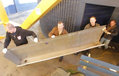 Leigh young bought the old piss trough from the mens bathroom at the old Winnipeg Stadium. His sons Cole and Chad and uncle Jim Nielsen on scene. Cole, Leigh, Chad, and Jim in photo. November 19, 2012  BORIS MINKEVICH / WINNIPEG FREE PRESS