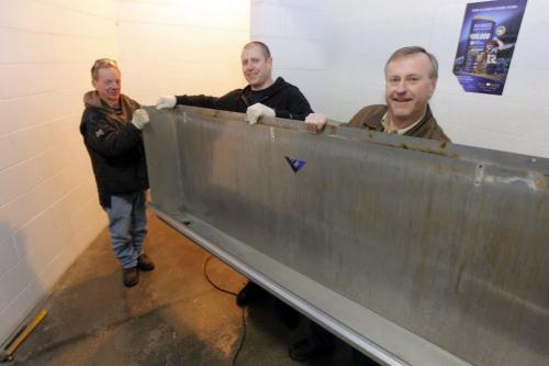 Leigh young bought the old piss trough from the mens bathroom at the old Winnipeg Stadium. His sons Cole and uncle Jim Nielsen on scene. Jim, Cole, and Leigh in photo. November 19, 2012  BORIS MINKEVICH / WINNIPEG FREE PRESS