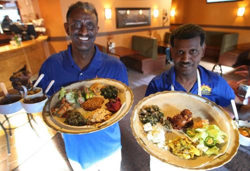 Gohe Ethiopian Restaurant- owner Elias Kebede, left, and chef Demisse Gitahun show meat and vegetarian combo plates-533 Sargent Ave-See Marion Warhaft restaurant review- November 20, 2012   (JOE BRYKSA / WINNIPEG FREE PRESS)