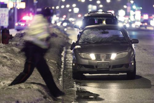 A police officer passes a car that was involved in a pedestrian/motor vehicle collision in Winnipeg Tuesday, November 20, 2012. Police closed northbound lanes of Pembina. (John Woods/Winnipeg Free Press)
