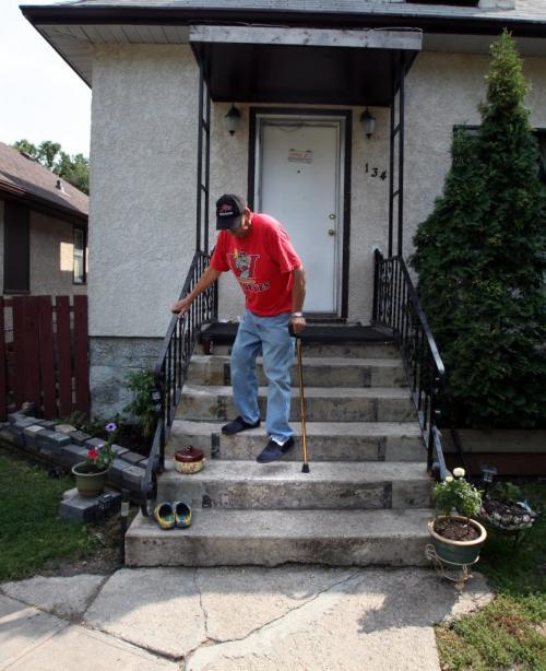 Bill Desjardins carefully lowers himself down the front steps of the St Boniface home he shares with his son and daughter-in-law. Both his artritic knees needed replacing. August 10, 2012 - Phil Hossack / Winnipeg Free Press